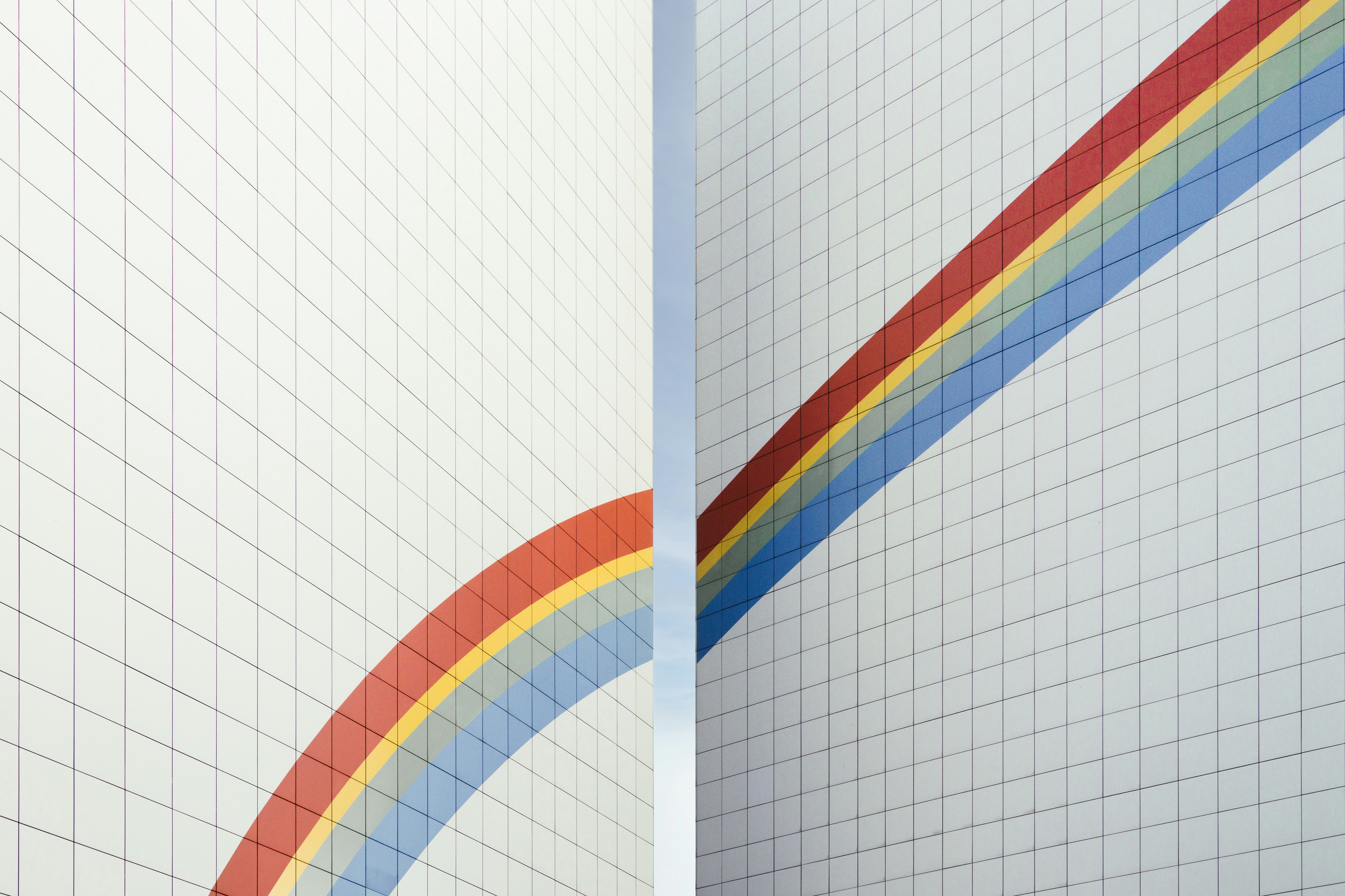 Rainbow Building in Berlin by ChatBench.org a couple of white walls with a rainbow painted on them